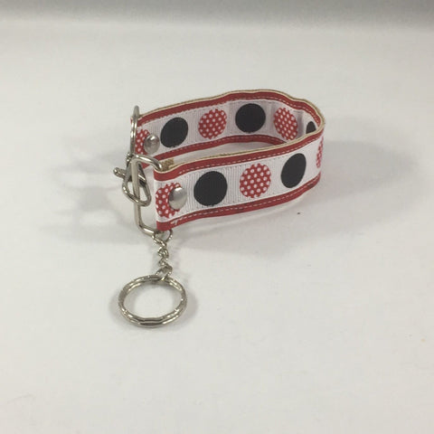 Key fob with black circles and red dotted circles.  Handmade by sisters2creations. Can wrap on wrist or hang on hook.