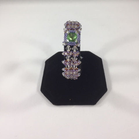Green Facet Bead surrounded by Crystal and Lavender beads in a weave.  Beaded Button Closure.  Size 6.5