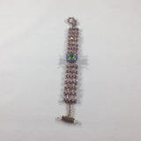 Bracelet, Green Facet Bead surrounded by Crystal and Lavender beads.  Size 6-1/2"