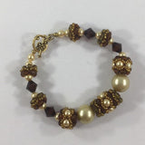 Bracelet, 7 handmade beads with Cream Swarovski Pearls and Dark Topaz, Gold tone