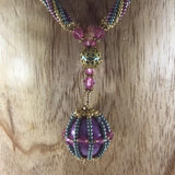 Glass Seed Bead Braided Rope Necklace with Glass Caged Ball Braided with Gold and Pastel Metalized Colors.  Length 14"