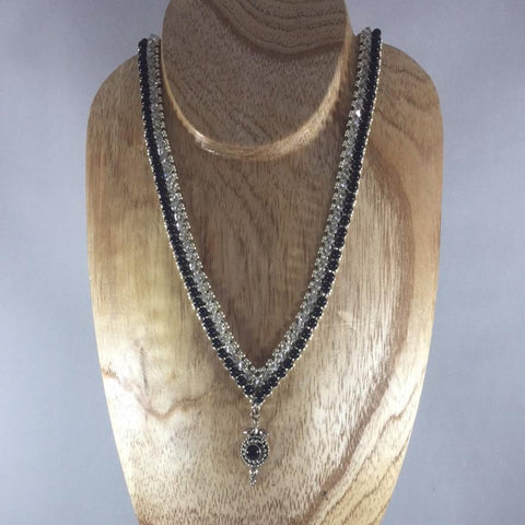 Exquisite beaded necklace with Czech Fire Polished Glass Beads, black rounds and an onyx pedant encased in tribe silver.  Sterling clasp.  Necklace is 18"