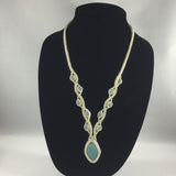 Elegant Bead work encasing Turquoise pendant.  Necklace 24" around.  Pendant 1.25"