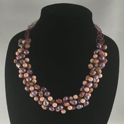 Hand crocheted wire necklace with shades of mauve and sand colored beads interwoven.  Necklace measures 23" around.