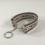 Accessory, Key Fob with a floral print and red border.  Handmade by sisters2creations. Can wrap on wrist or hang on hook.