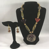 Strung Large Ceramic Geometric shaped beads with a Lion face pendant.  Gold tone.  Necklace 18".  Pendant is 1 3/4".  Earrings included.