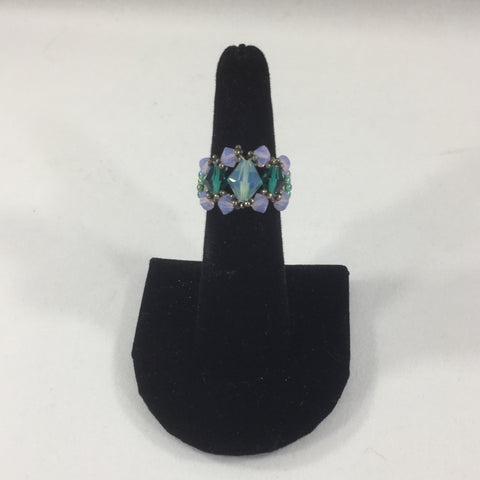 Beaded Ring with Aquamarine Swarovski Bicone and 2 Turquoise Bicones.  Lavender Bicone Accents.  Aqua Band. Size 6.  Because this ring is strung with thread, constant exposure to water is not recommended.