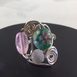 Ring, Sterling Wire Wrap with 3 Glass Beads, 2 pink and one green with a flower on it.  Size 9 1/4