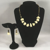Chunky white bead necklace with faceted gold tone beads.  Necklace measures 16 1/4" around.  Earrings included.