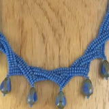 Weaved Necklace with Blue Glass Seed Beads and Glass Picasso Turquoise Drops.Length 17".  Button clasp. Sterling earrings included.