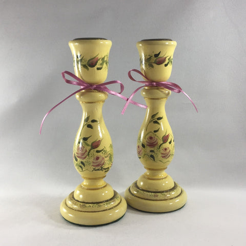 Candlestick, Antique Cream background with pink Roses.  Hand painted on turned wood with 6 coats of gloss.  Brass candle holder ring and felt padded on bottom to prevent damage to furniture.  7" tall.