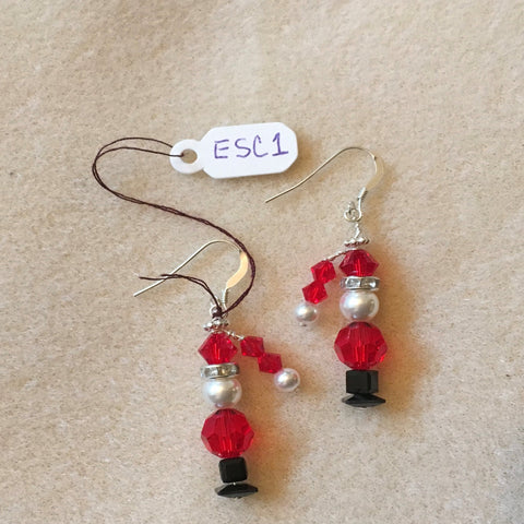 Pierced Earrings on Sterling Ear Wires.  Santa is made with a Red Swarovski Round Bead, a White Swarovski Pearl, a Red Swarovski Bicone and a Hat with Two Small Red Swarovski Bicones and a small White Swarovski Pearl.