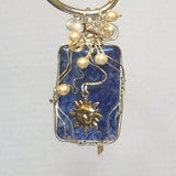 Wire Wrapped Blue Agate stone with Swarovski Pearls and a Sun Charm.  Sterling silver.