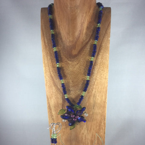 Lapis blue disk beads, Czech faceted green glass beads.  Handmade flower Pendant. Sterling. Earrings included.  Necklace 25" with 3" flower