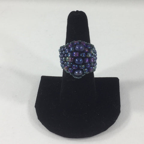 Ring, Beaded Weave, Purples and Indigo Glass Seed Beads.  Size 7 1/2. Although this ring is strung with Fireline, constant exposure to water is not recommended.