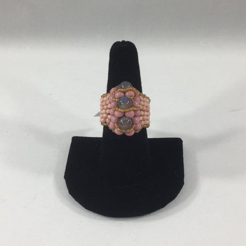 Pink Glass Seed Bead Ring with Gray Accent Beads.  Size 7 1/4.  Although this ring is strung with Fireline, constant exposure to water is not recommended.