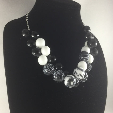 Hand Blown Glass Bead necklace with Sterling chain.  These beads were hand-blown by Anna Scherbakova who lives in Russia. She used black and white rods to create each glass ball.  Then the balls were kiln annealed for hardness and finished with a dremel.  The necklace measures 18".