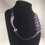 Hand Blown Glass Bead necklace with Sterling necklace chain.  These beads were hand-blown by Anna Scherbakova who lives in Russia. She used hues of purples to create each glass ball.  Then the balls were kiln annealed for hardness and finished with a dremel  The necklace measures 20"